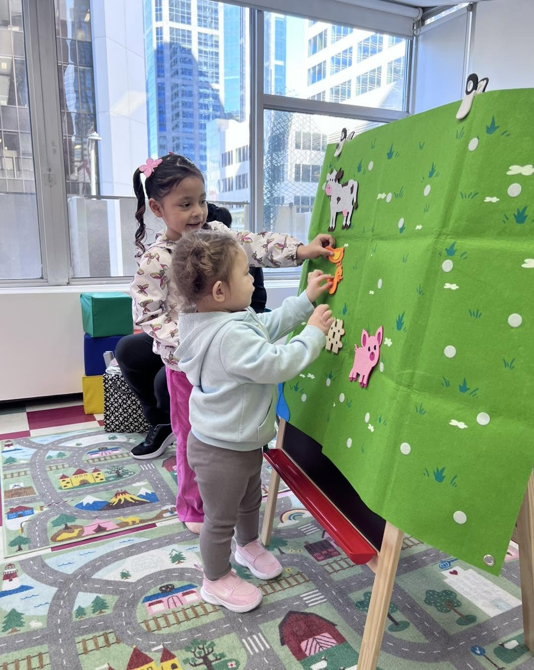 Children playing with a classroom felt activity